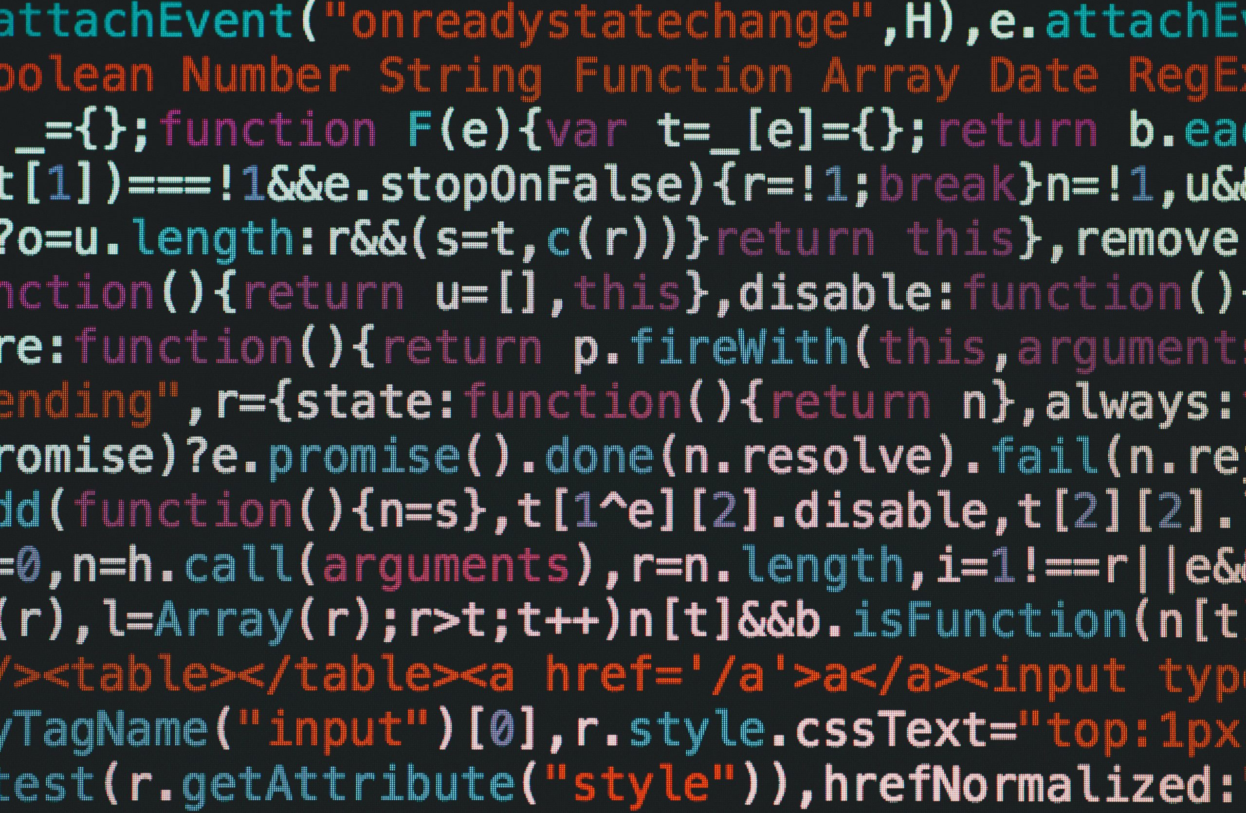 Close-up of colorful coding text on a dark computer screen, representing software development.